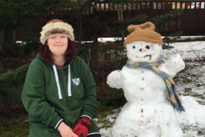 Irish EVS volunteer Catriona and a snowman in Finland.