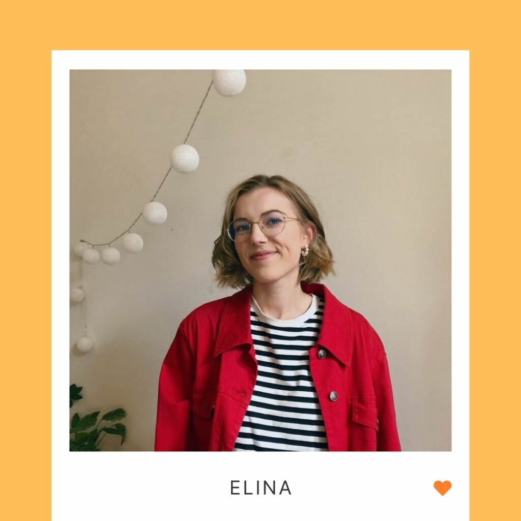 A smling person in front of a wall, on the wall there are decorative lights, under the photo the text "Elina" and an organge heart.