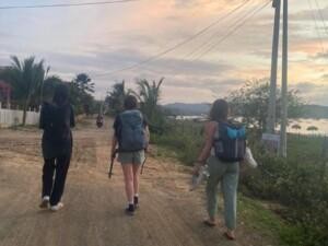 Three people walking avay from th