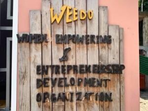 A sign that says "WEEDO Women empowerment & entrepreunership development organization".